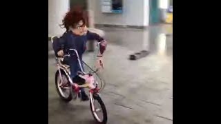 Kid Pulls Off A Seat Stand Bike Trick While Wearing Chucky Costume