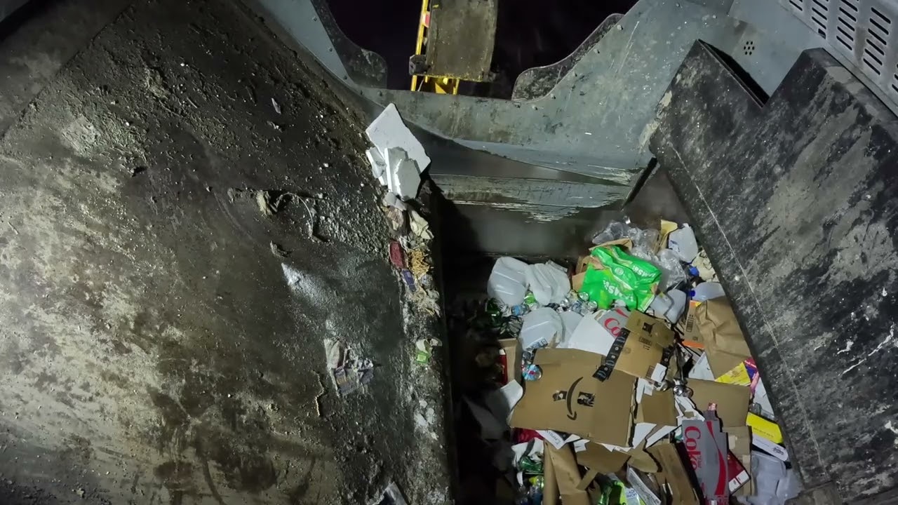 Garbage truck hopper POV: Post holiday recycling