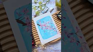 simple watercolor cherry blossoms with pastel blue background