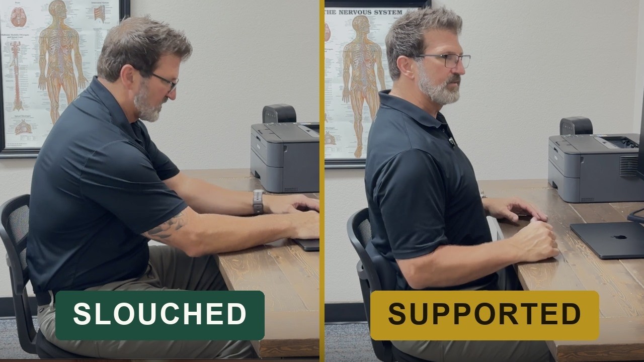 Dr. Jeremy Taylor demonstrating seated desk posture and low back support in Fort Worth