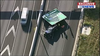 Sign falls on car on freeway