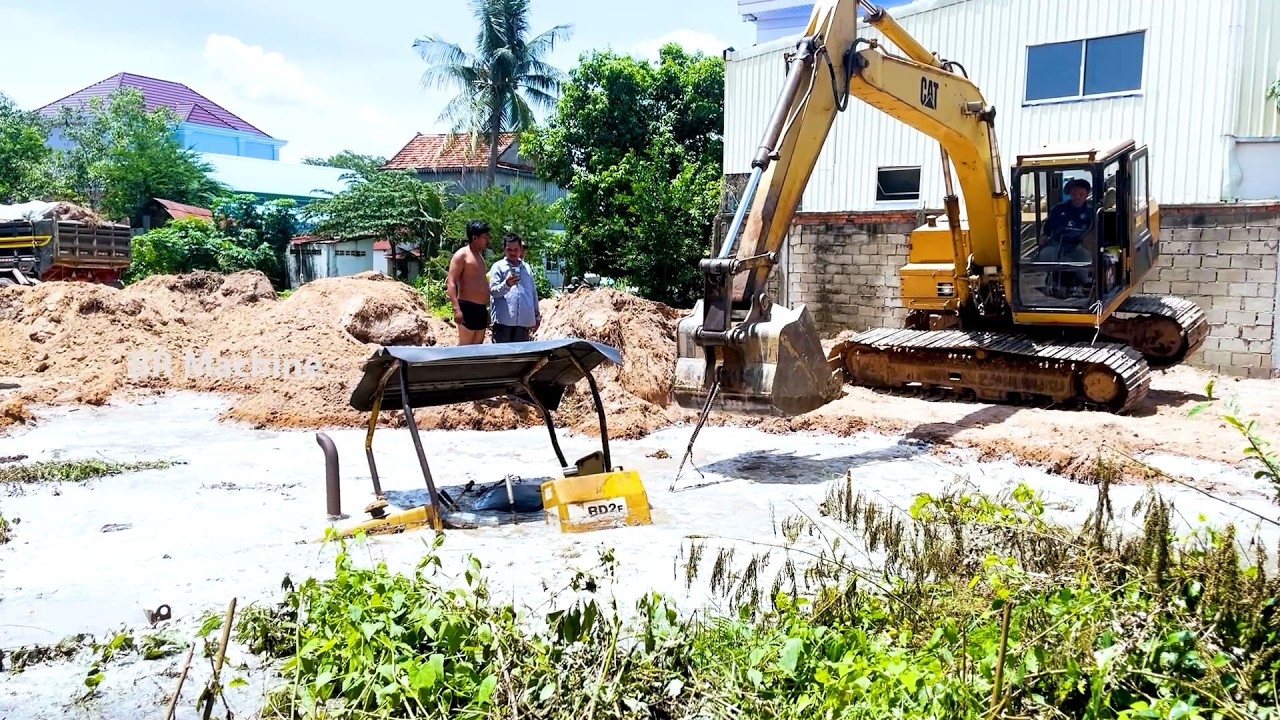 BULLODZER FALL wile push the soil into the deep pond and EXSCAVATOR rescue