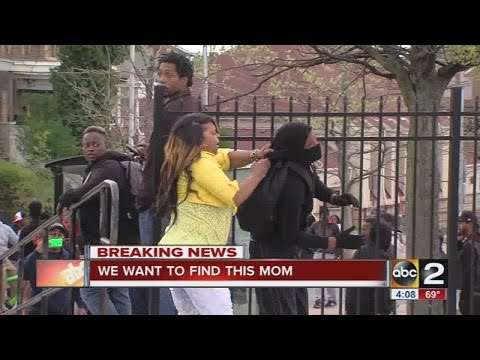 Story behind the video: Mom beats son for throwing rocks at police in Baltimore