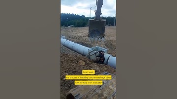 Smart work - the process of installing concrete drainage pipes with the help of an excavator