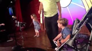 Gallagher comedian on stage with his grand kids Information