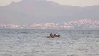 Iranian refugees paddle toward the beaches of Kos