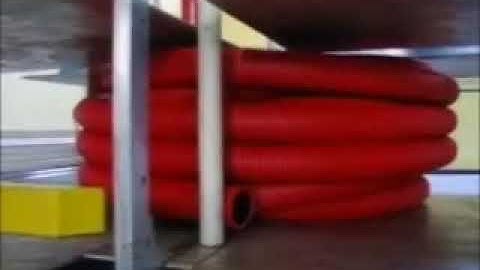 Automatic hose coiler with strapping machine