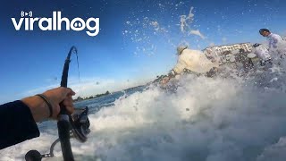 Fisherman Knocked Down by Wave While Fighting a Large Catch || ViralHog