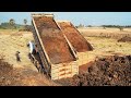 Working in tandem with heavy dump trucks, the bulldozer can assist in loading and unloading dirt