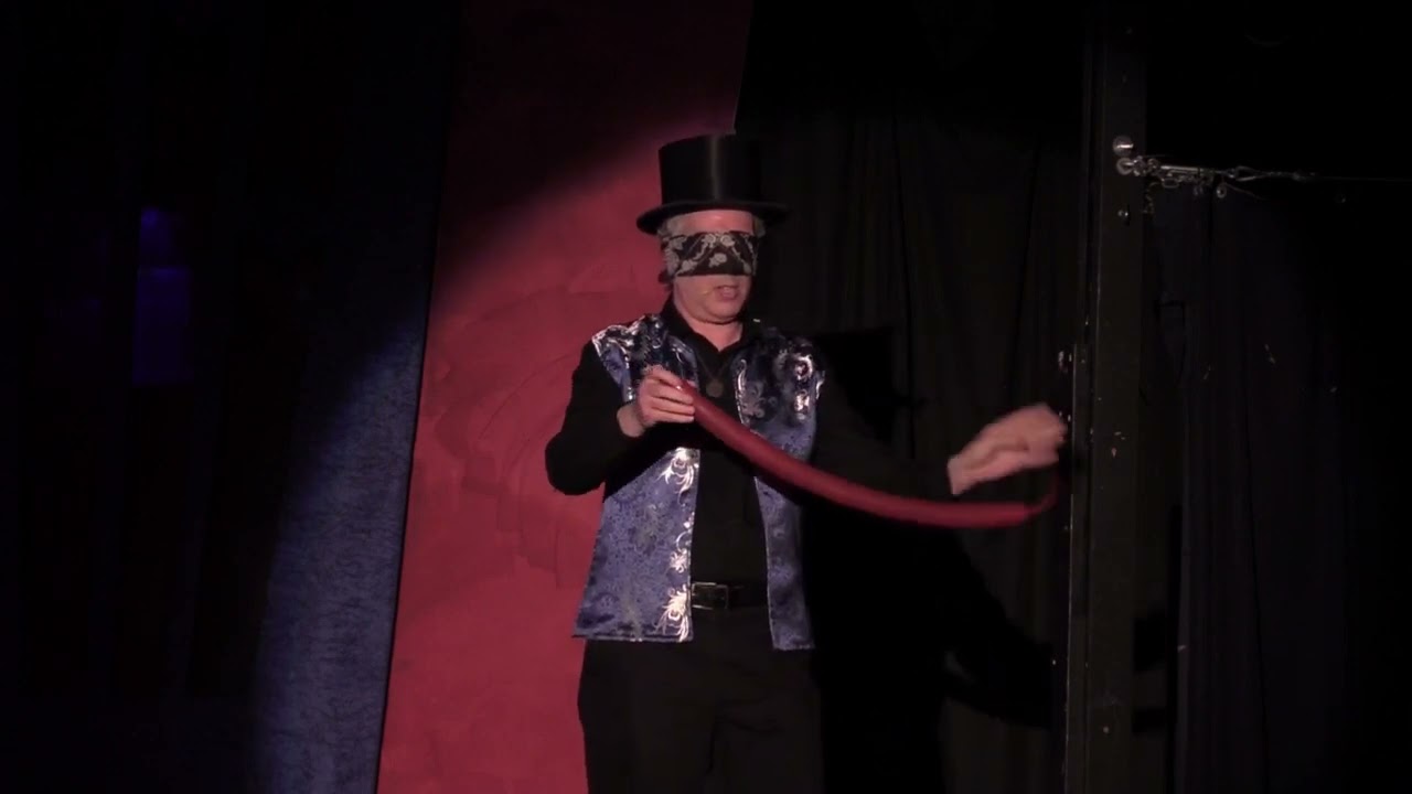 Dr. Owl twists a balloon without looking.