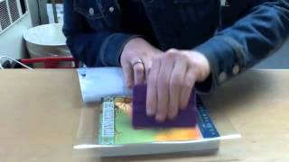 This explains how to cover a paperback book with clear contact paper.
