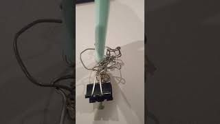 tiny bear trap made out of paper clips