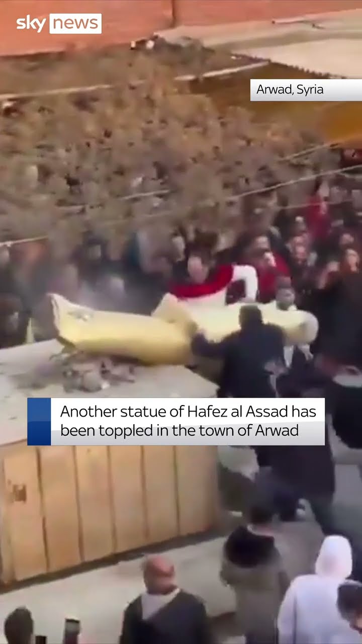 Toppled Assad statue dragged through streets