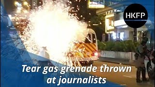 Hong Kong police throw tear gas grenade at journalists on pavement