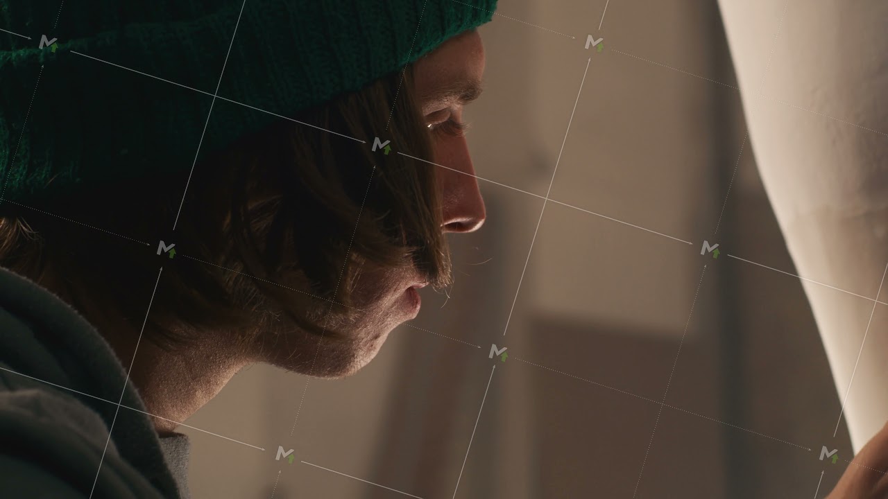 Young man creating sculpture in workshop
