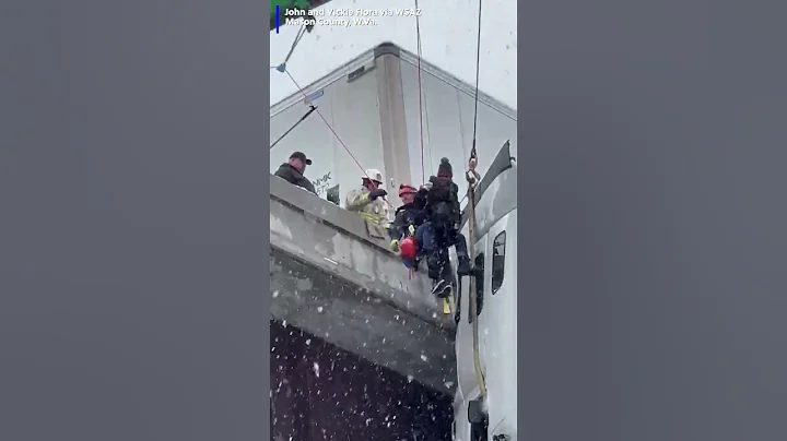 Video shows the dramatic rescue of a driver from a semitruck cab as it dangles off an overpass