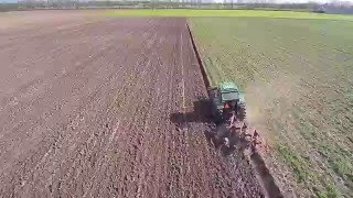 Tractor plowing field filmed with drone Yuneec Q500