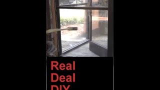 Demolition. Sledge hammer through glass doors