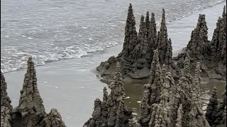 Sandcastle destroyed by waves