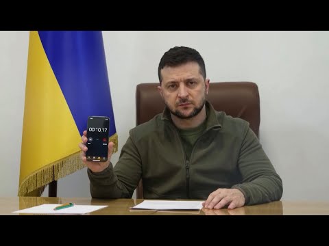 Volodymyr Zelensky plays air raid siren during speech