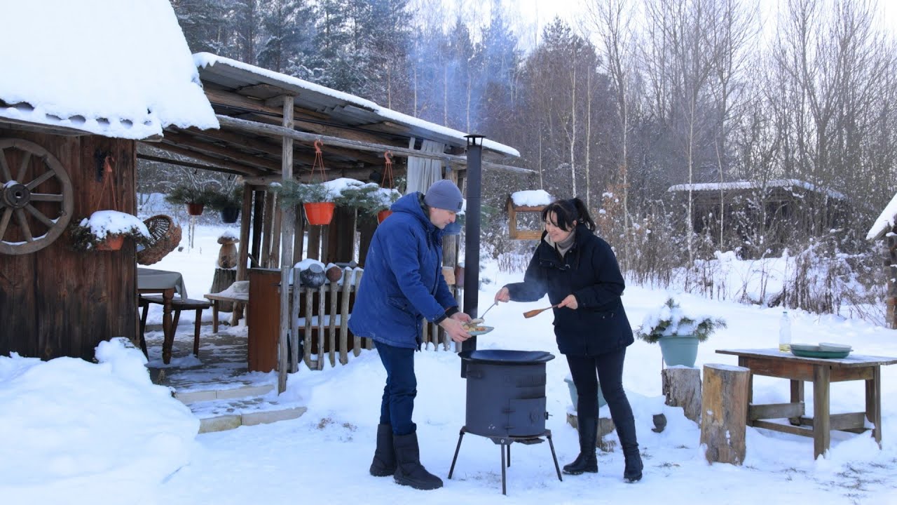 A snowy day in the village. Rural life in winter. Cleaning and cooking outside.
