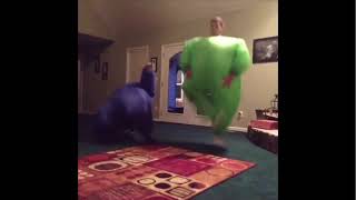Two Men Dancing In Inflatable Costumes