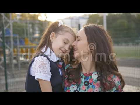 School Daughter and Mother Kissing on Lips