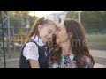 School daughter and mother kissing on lips