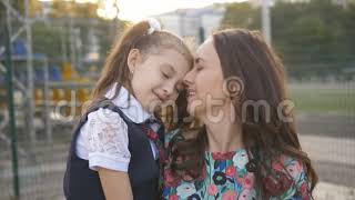 School Daughter And Mother Kissing On Lips