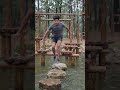 obstacle course. Handheld tracking follows her as she lands on a wooden platform