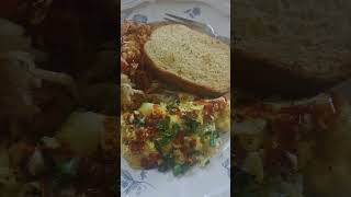shredded hash browns , scrambled eggs and garlic bread