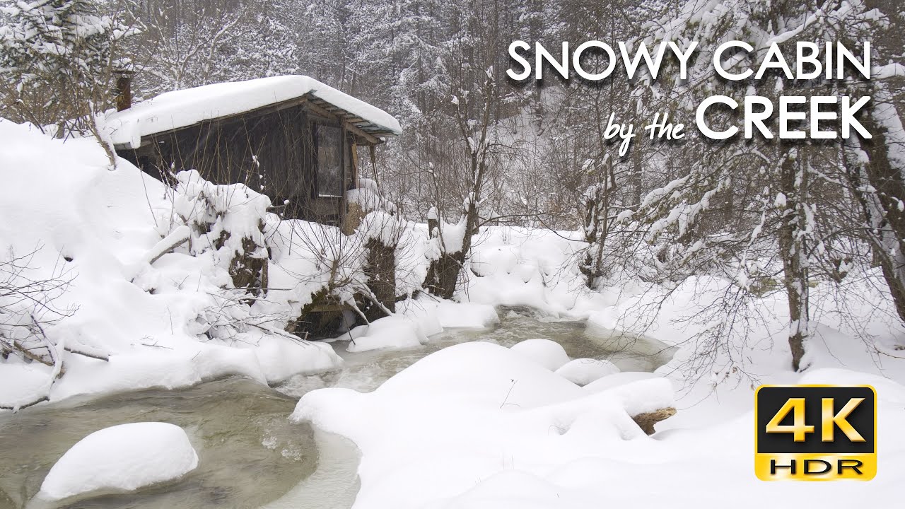 4K HDR Snowy Cabin by the Creek - Snow Blizzard & Stream Sounds - Cozy Forest Hut & Winter Ambiance