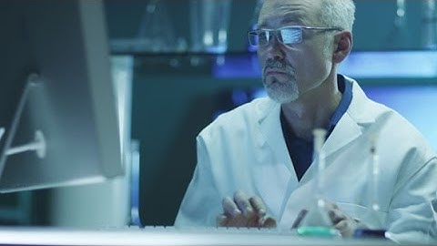 Scientist is Working on Computer in Laboratory | Stock Footage - Videohive
