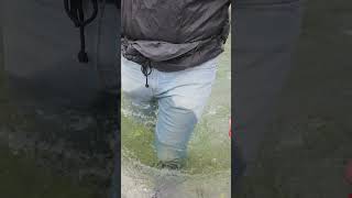 wet jeans and rubber boots