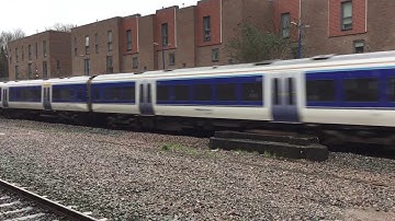 Chiltern Railways class 165 Turbo flies through Wembley Stadium in rainy weather.