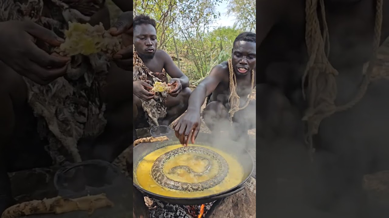 Hadzabe eating roasted meat beside the campfire.