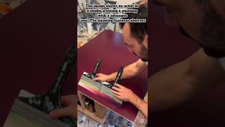 a painting using a squeegee to apply and shape paint on a large canvas
