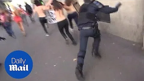 Police officer distracted by topless Femen protest runs into wall - Daily Mail