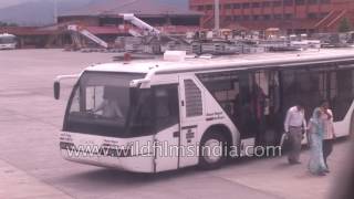 Passengers dis-embark from airport bus, board plane at Tribhuvan airport, Kathmandu
