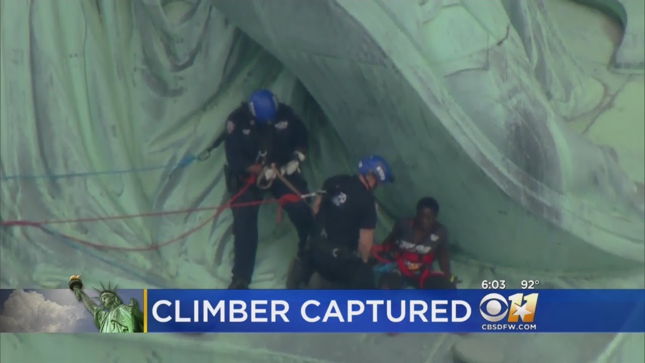 Protester Apprehended After Climbing On Base Of Statue Of Liberty - YouTube