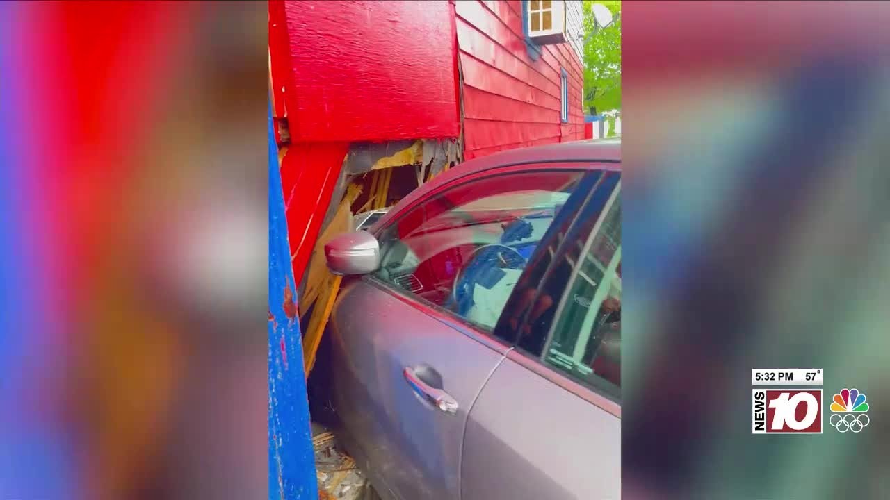 Stolen car crashes into building after nearly hitting police car - YouTube