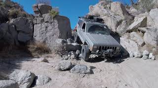 Jeep Cherokee XJ Doing the Squeeze both ways in Anza Borrego Pinyon Mountain Trail