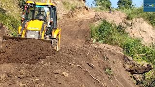 Fearless JCB Operator Working on a Hilltop Narrow Road