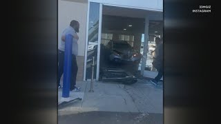 Two in critical condition after disgruntled customer drives into CarMax showroom