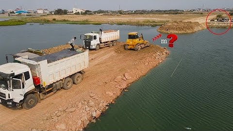 Wonderful Making The Best Road on Water Mighty Bulldozer SHANTUI Spreading Stone and Truck Unloading