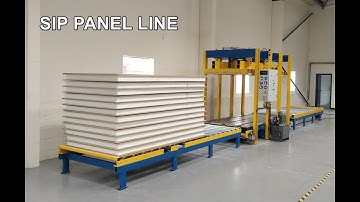 SIP panel house production. SIP panel gluing. SIP panel pressing.