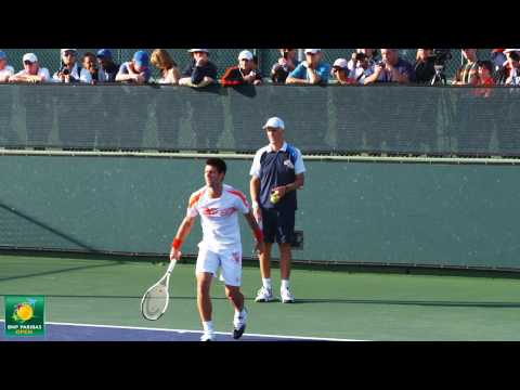 Novak Djokovic and Todd Martin practice serving dr...