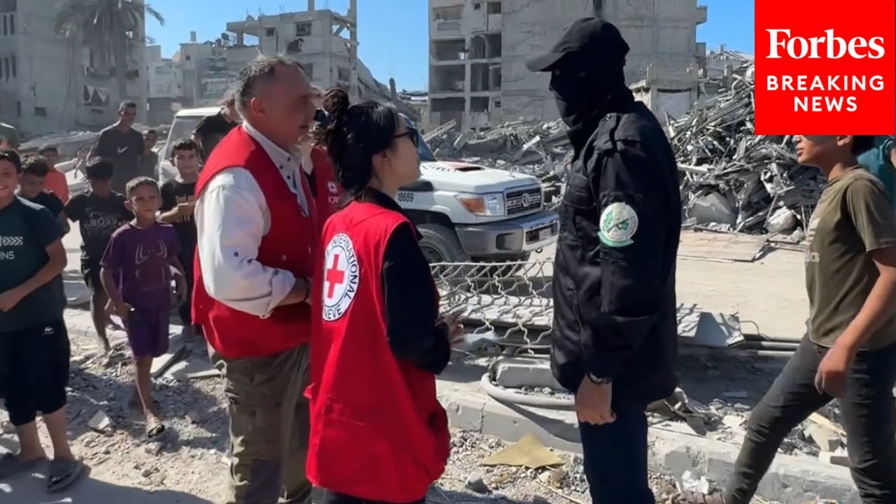 Members Of Hamas' Al-Qassam Brigades Speak To Red Cross Teams During Hostage Recovery Efforts