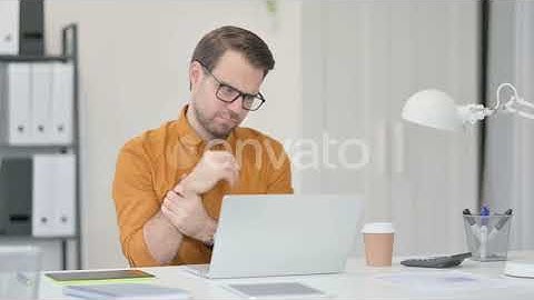Young Man Having Wrist Pain in Office | Stock Footage - Envato elements