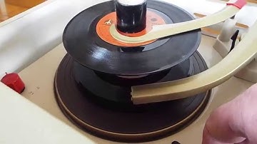 V-M 1290 automatic record player playing a stack of 45 records